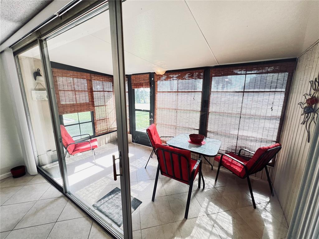 a living room with furniture and a floor to ceiling window