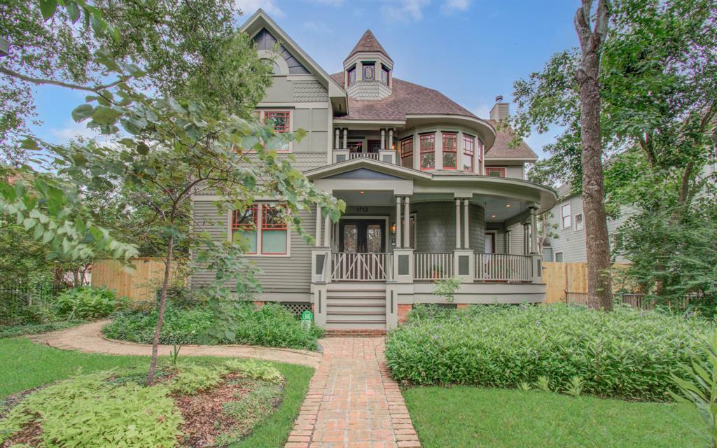 Live on Heights Boulevard in this charming three-story Victorian-style home featuring a distinctive turret, wrap-around porch, and an oversize lot. The house is set back from a brick pathway amidst lush Texas native landscaping