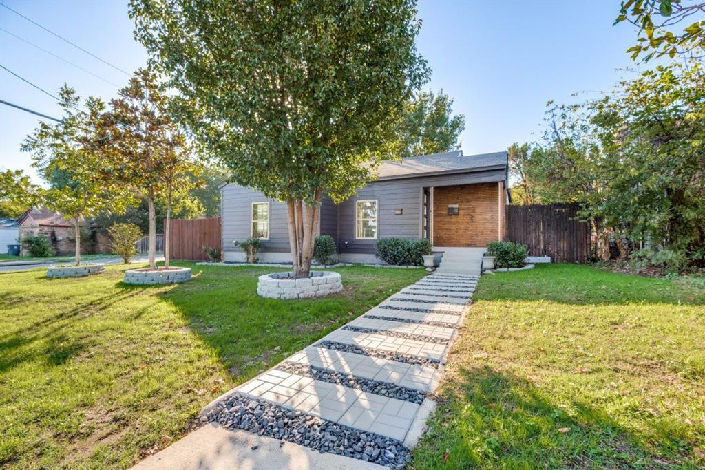 a front view of a house with yard and green space