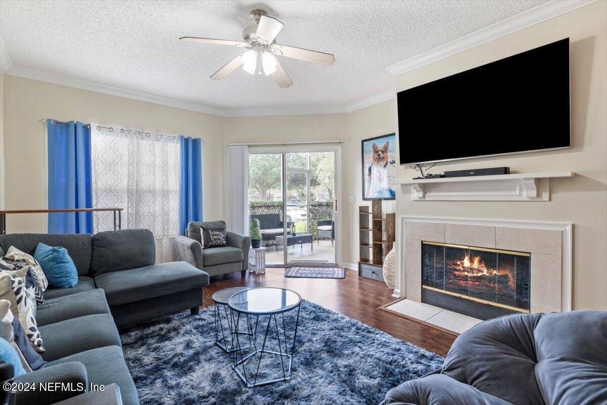 a living room with furniture a flat screen tv and a fireplace