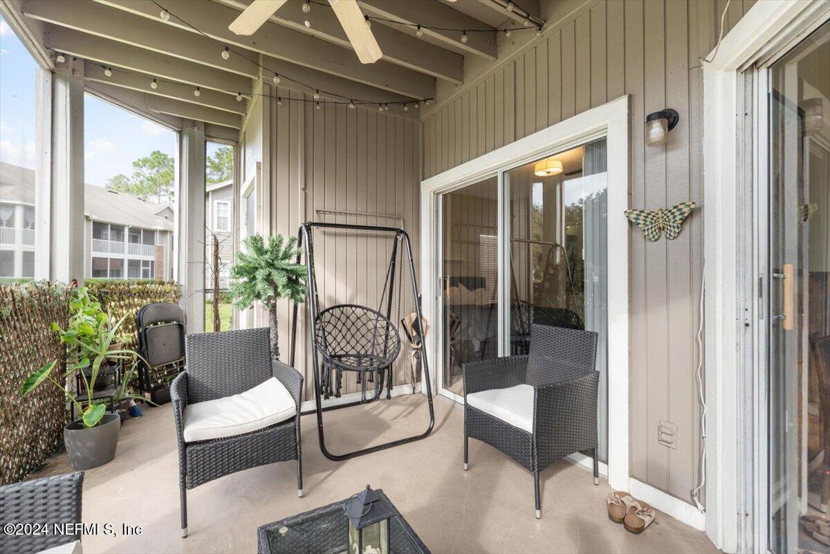 a building outdoor space with patio furniture and potted plants