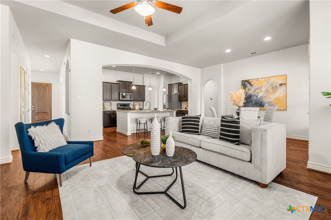 a living room with furniture and kitchen view