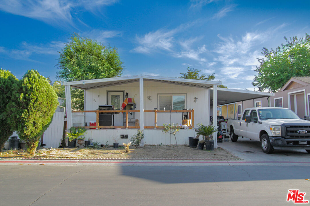 a front view of a house with a yard and parking