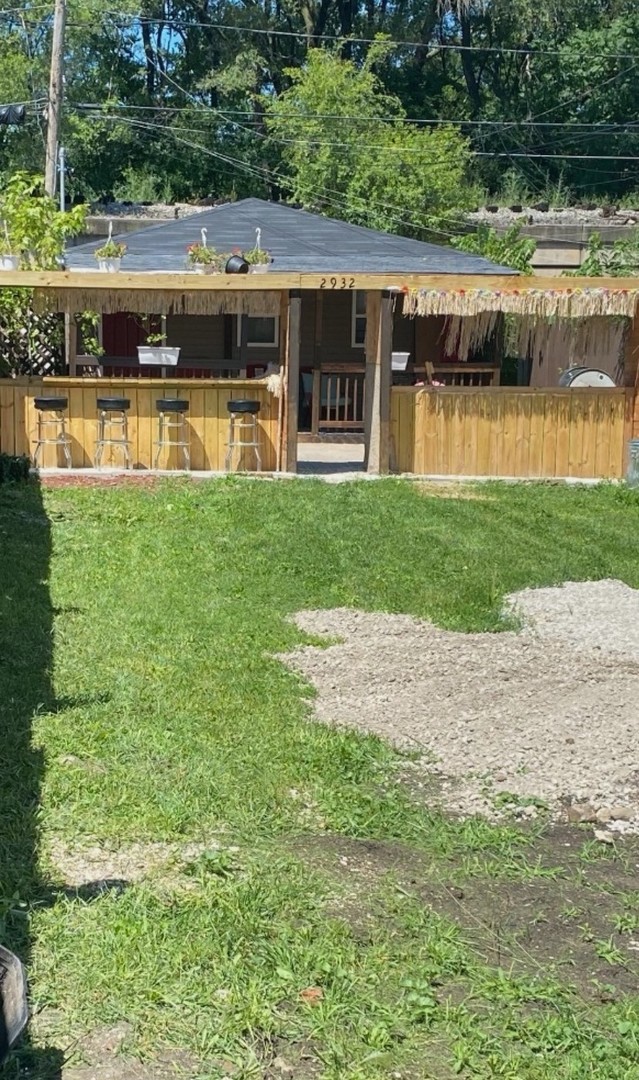 a view of a house with a yard from a lake view