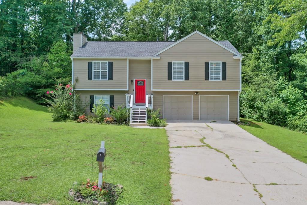 a front view of a house with a yard and garage