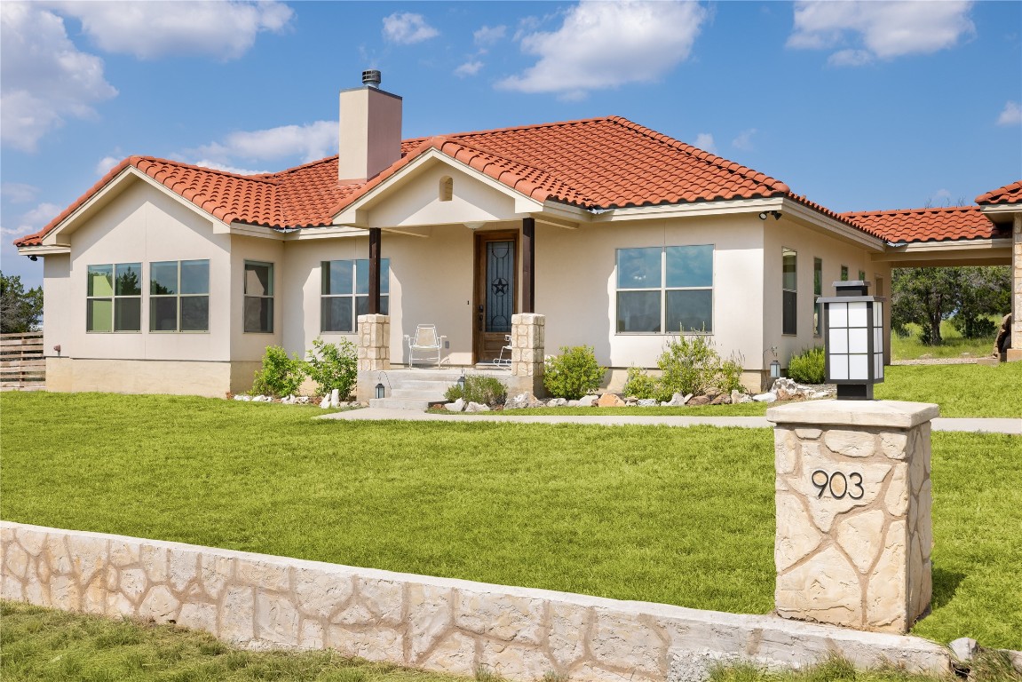 a front view of a house with garden