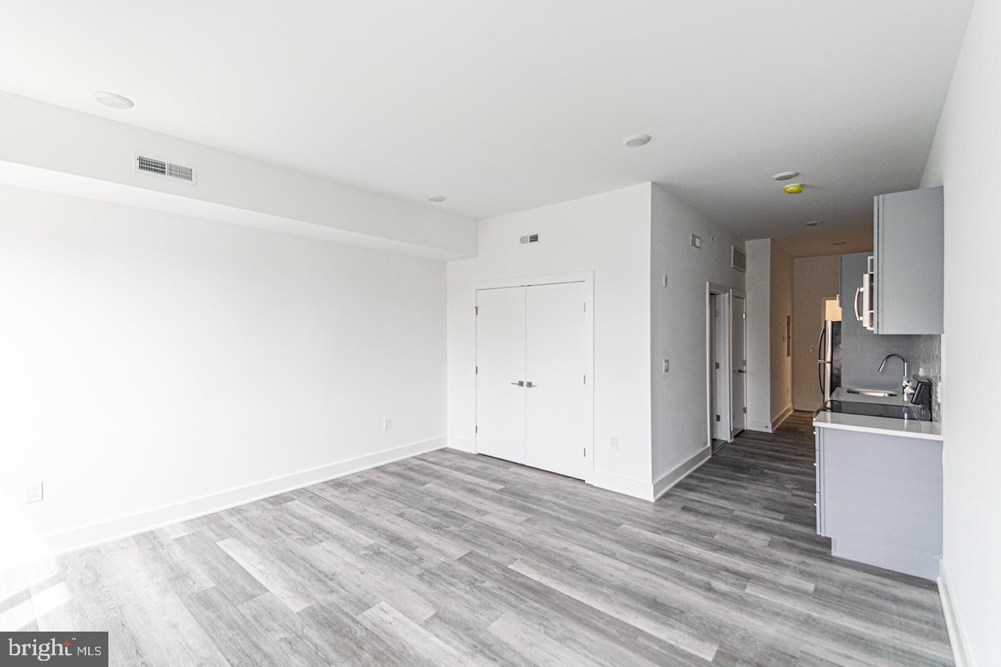 a view of a kitchen cabinets and wooden floor