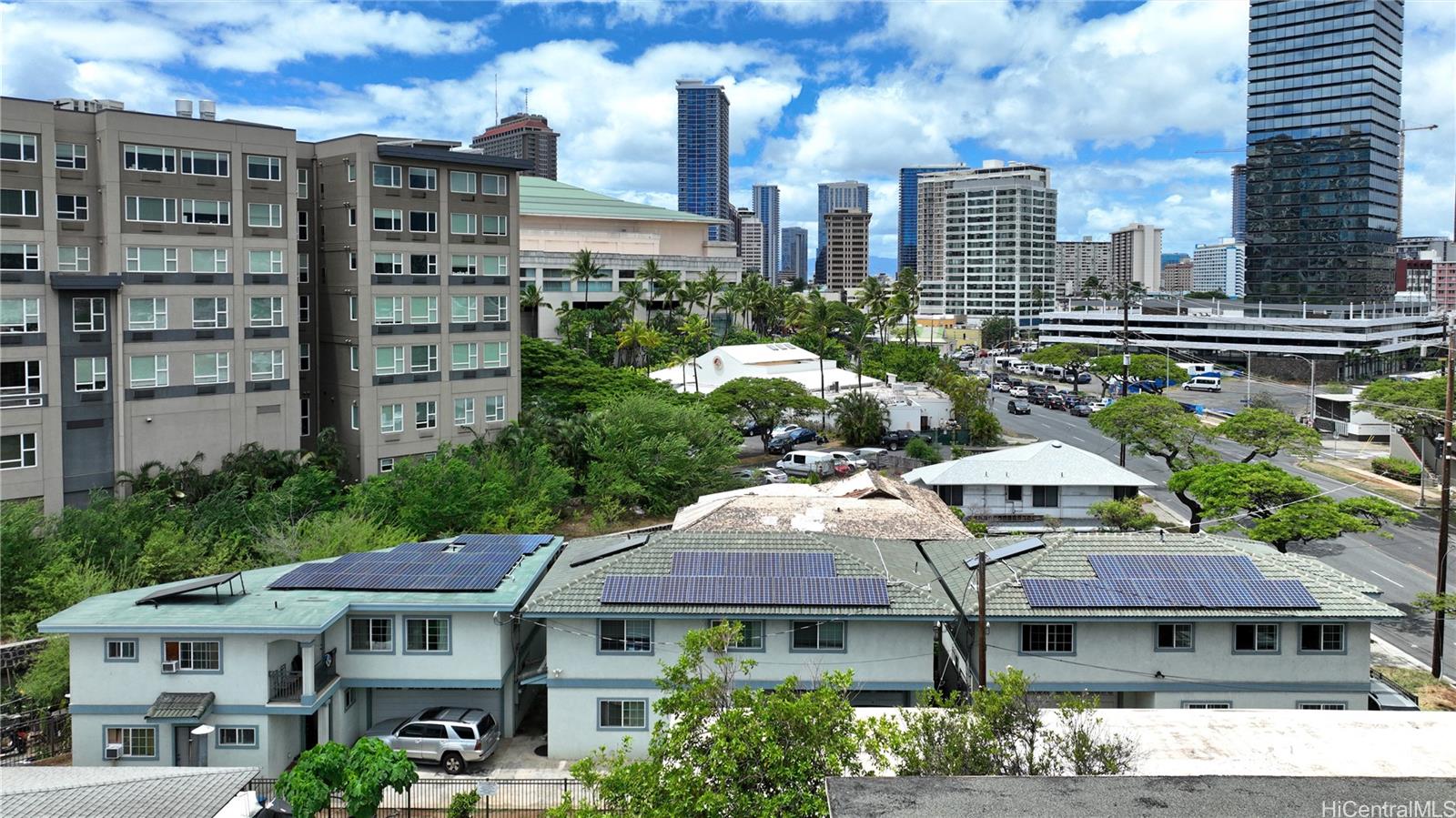 a front view of a residential apartment building with a yard