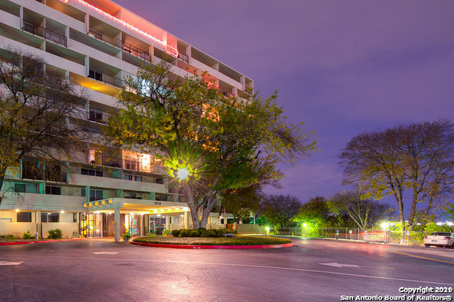 a front view of a building with trees