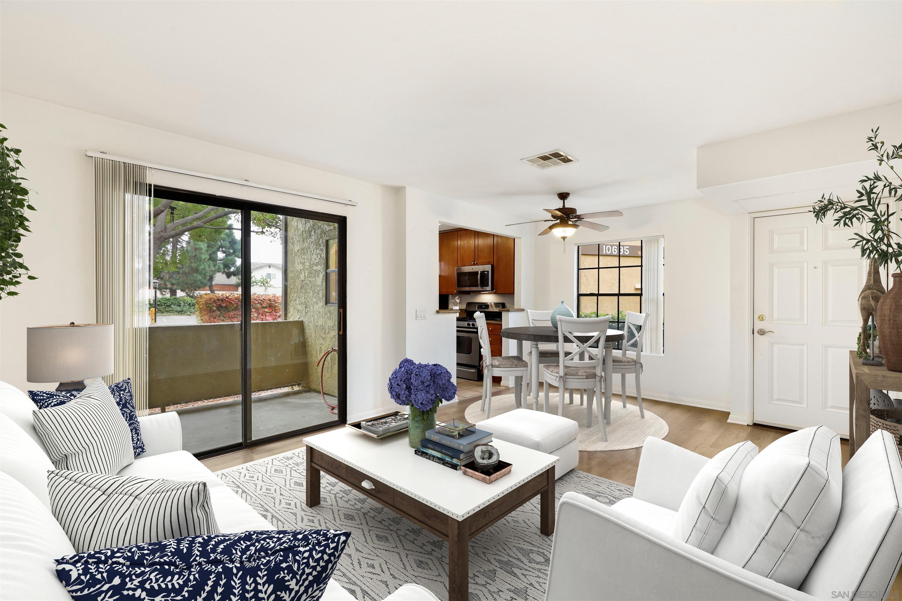 a living room with furniture and a floor to ceiling window