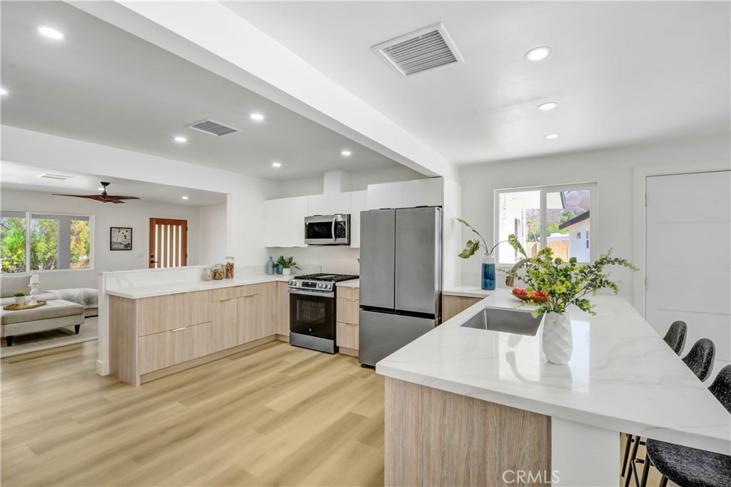 a kitchen with refrigerator and stove