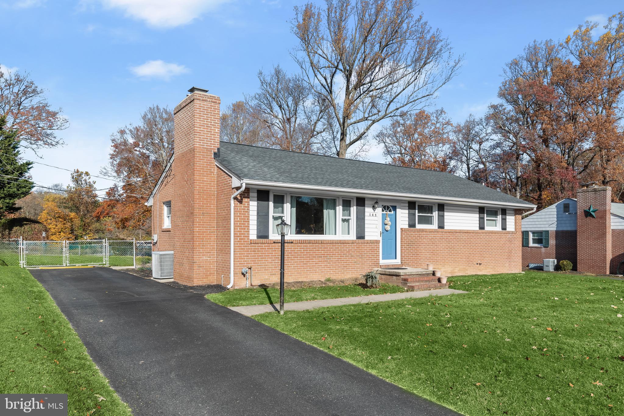 a front view of house with yard and garage