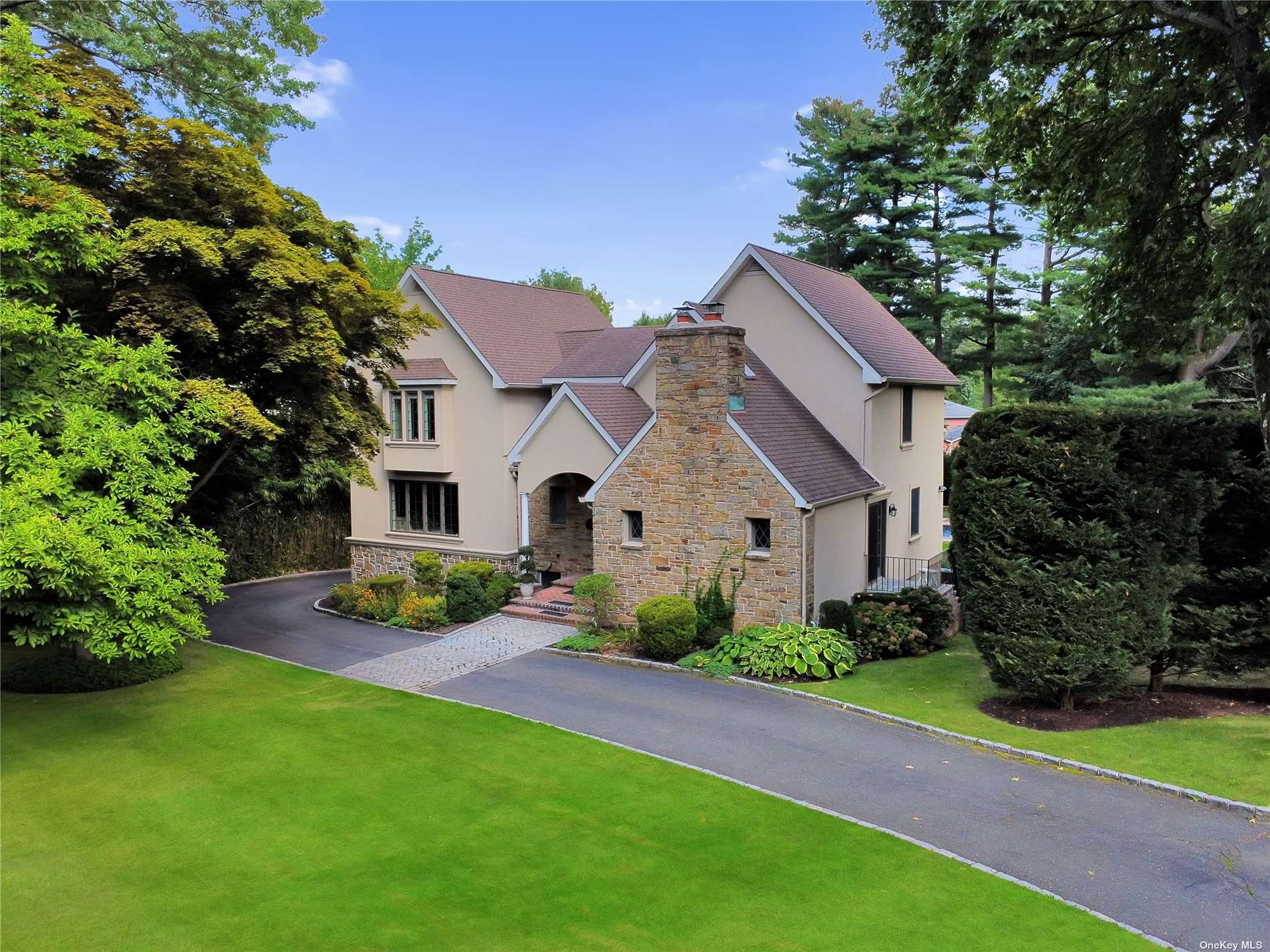 a front view of a house with a garden and yard