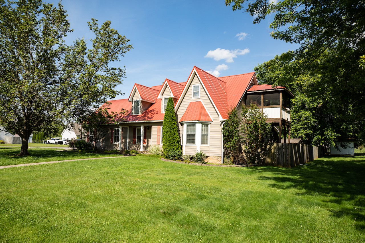 a front view of house with yard and green space