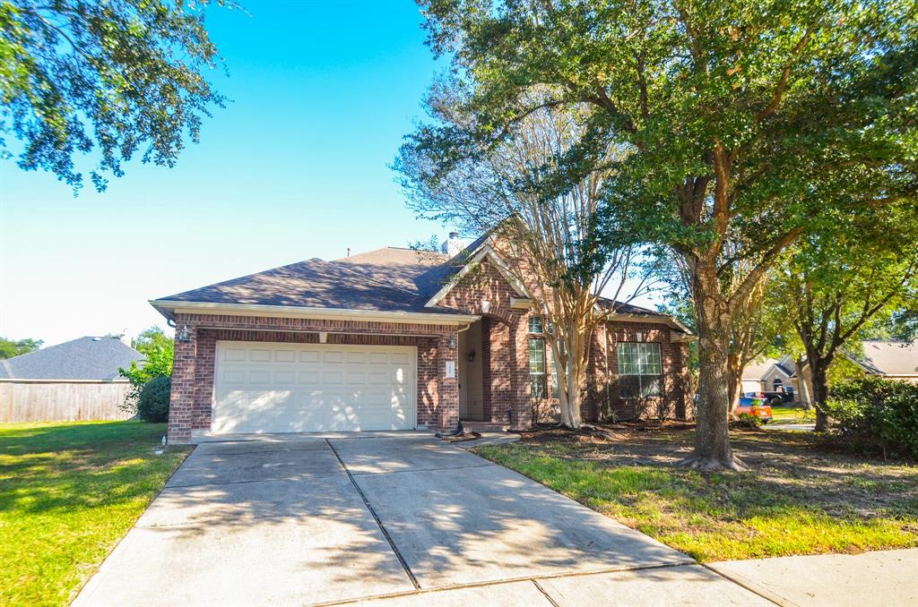 a front view of a house with a yard garage and outdoor seating