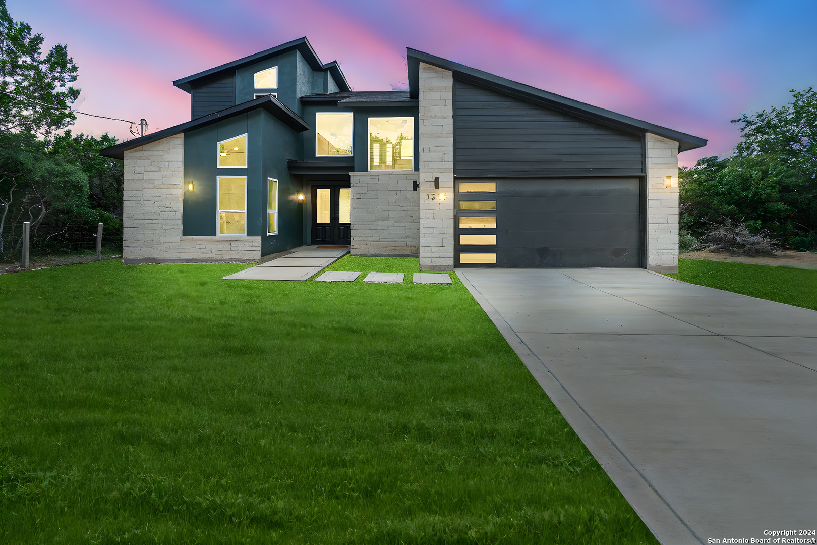 a front view of a house with a yard and garage