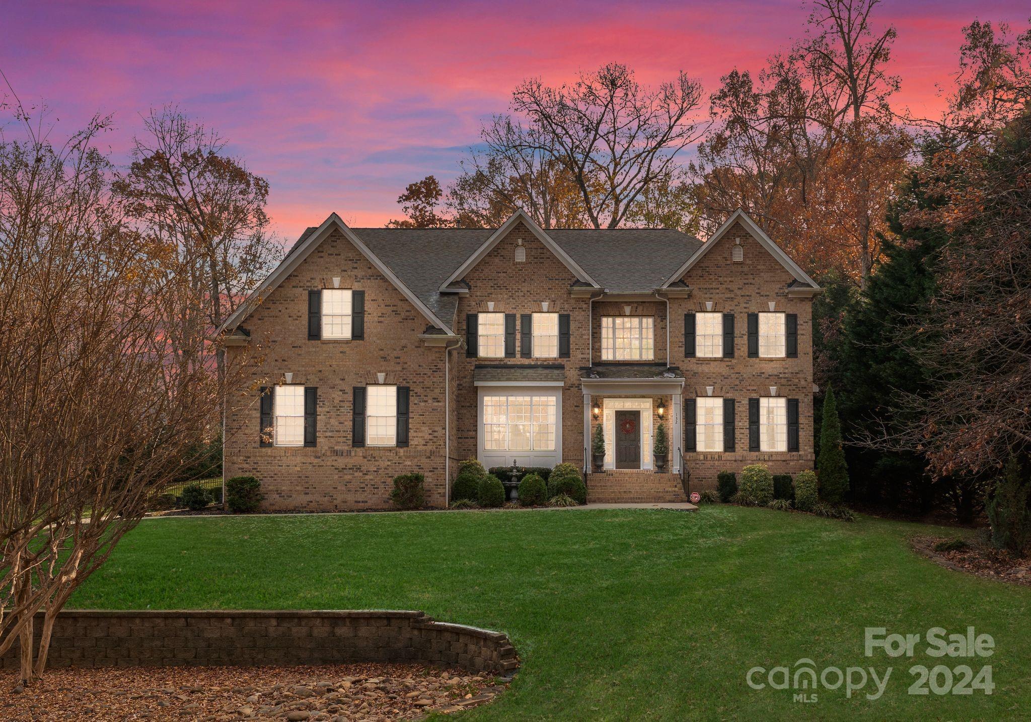 a front view of a house with a garden