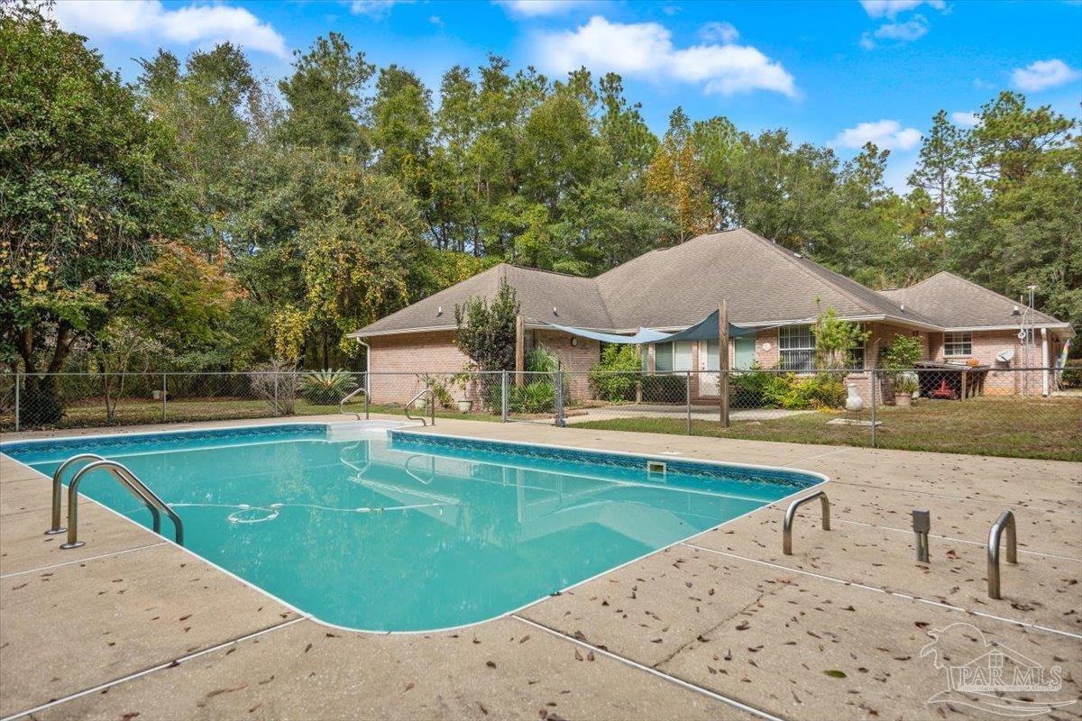 a view of house with outdoor space and swimming pool