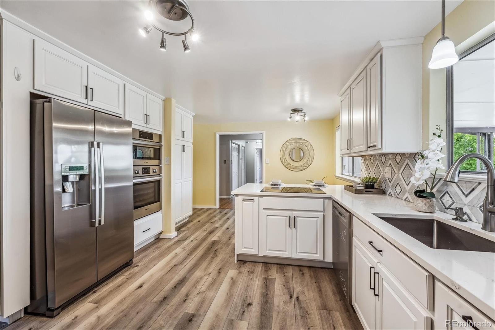 a kitchen with a sink stove and refrigerator