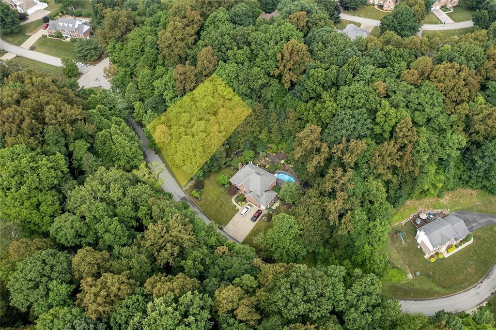 an aerial view of a house with yard swimming pool and outdoor seating