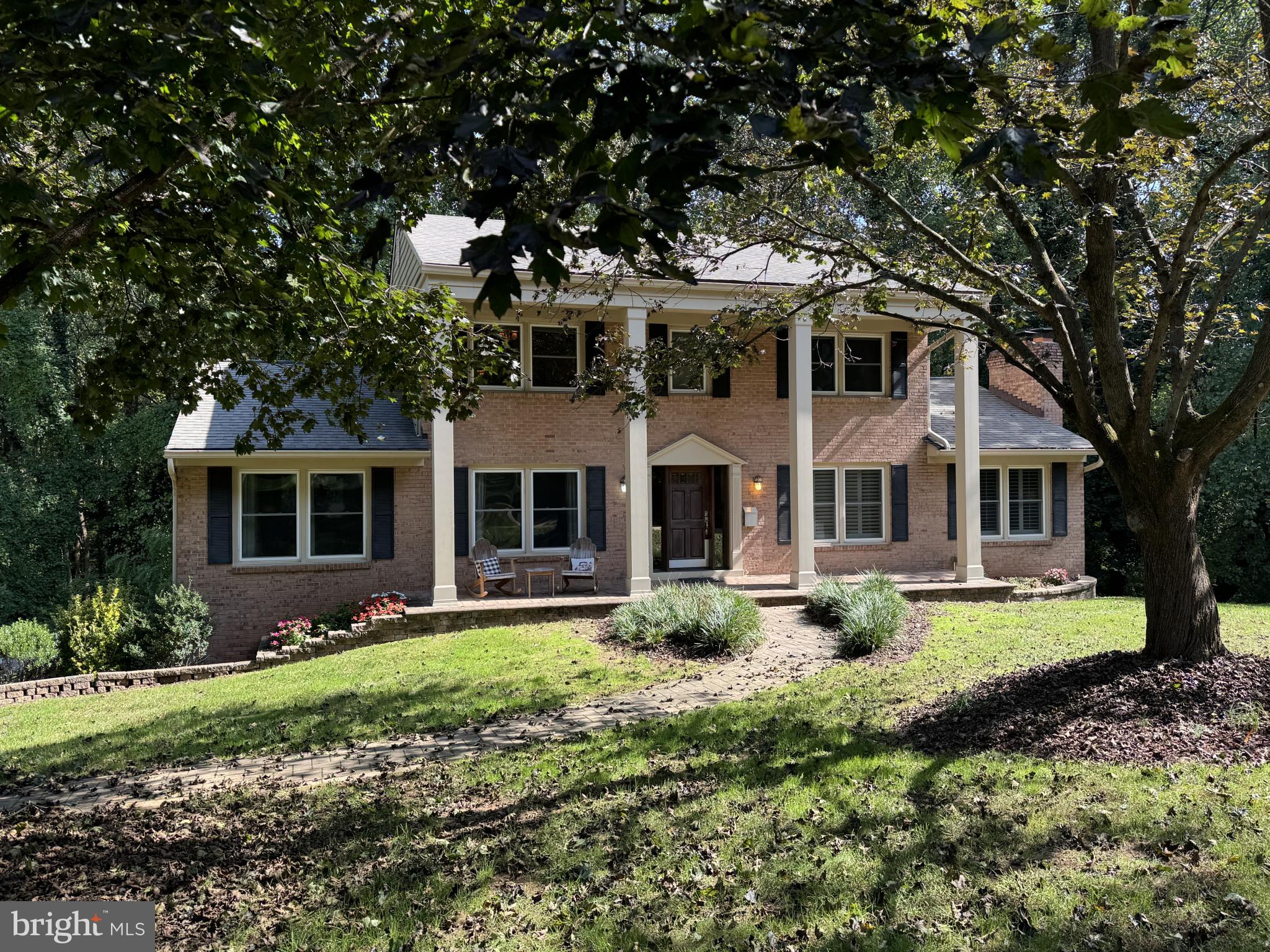 a front view of a house with garden and porch