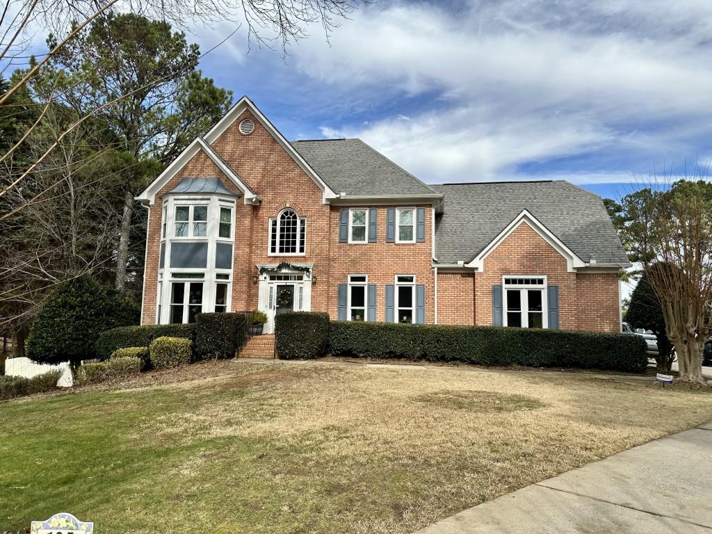 a front view of a house with a yard