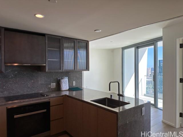 a kitchen with granite countertop a sink and cabinets