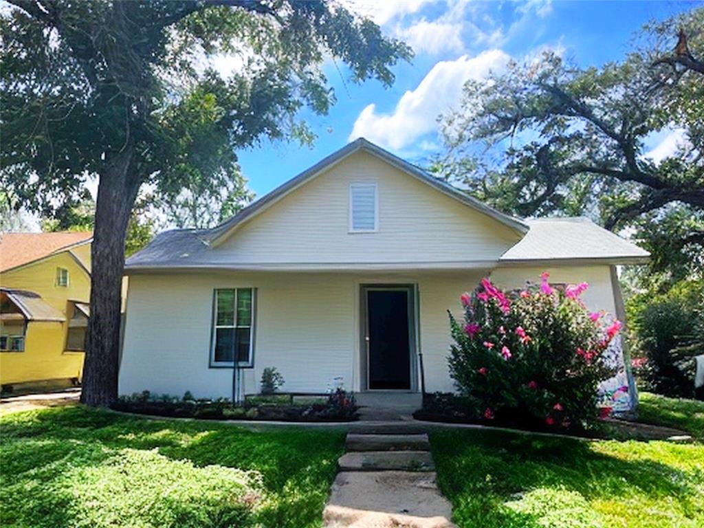 a front view of house with a garden