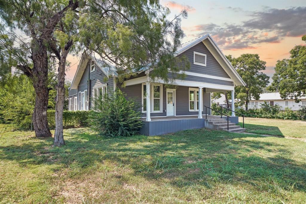 a front view of house with yard and green space