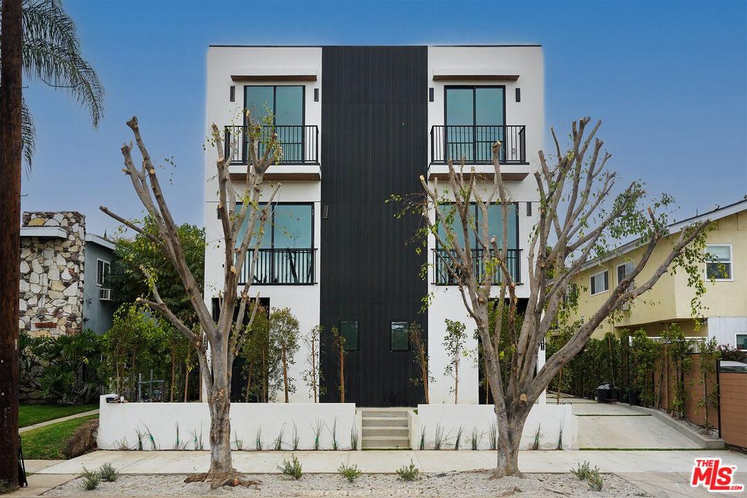 a view of a building with a tree front of house