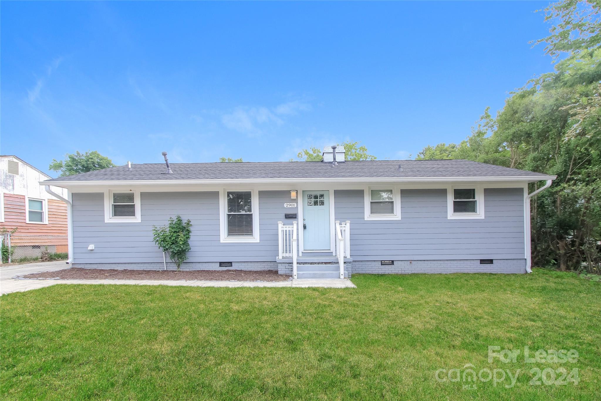 a front view of house with yard and outdoor seating