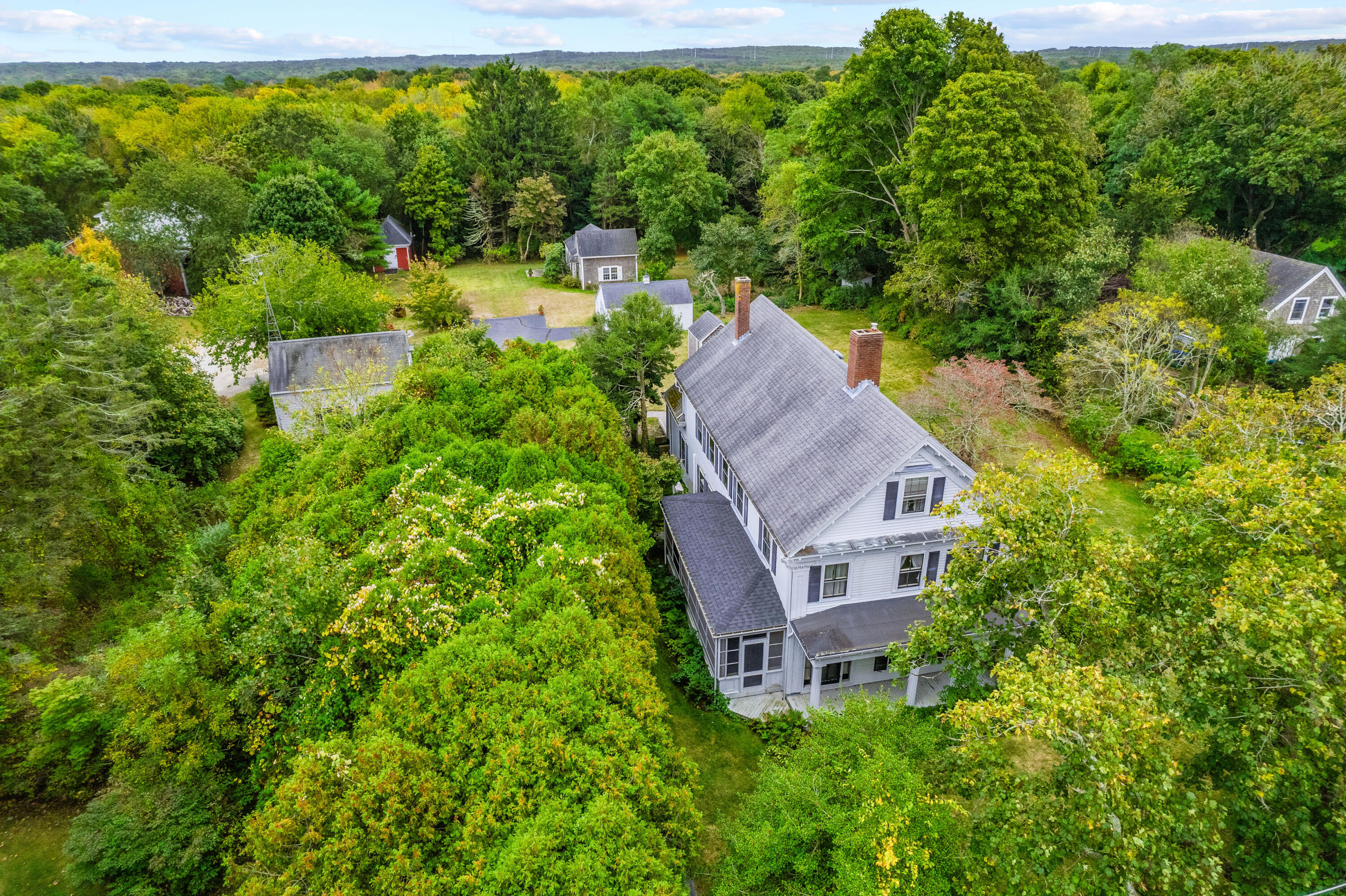 an aerial view of a house with garden space and a street view