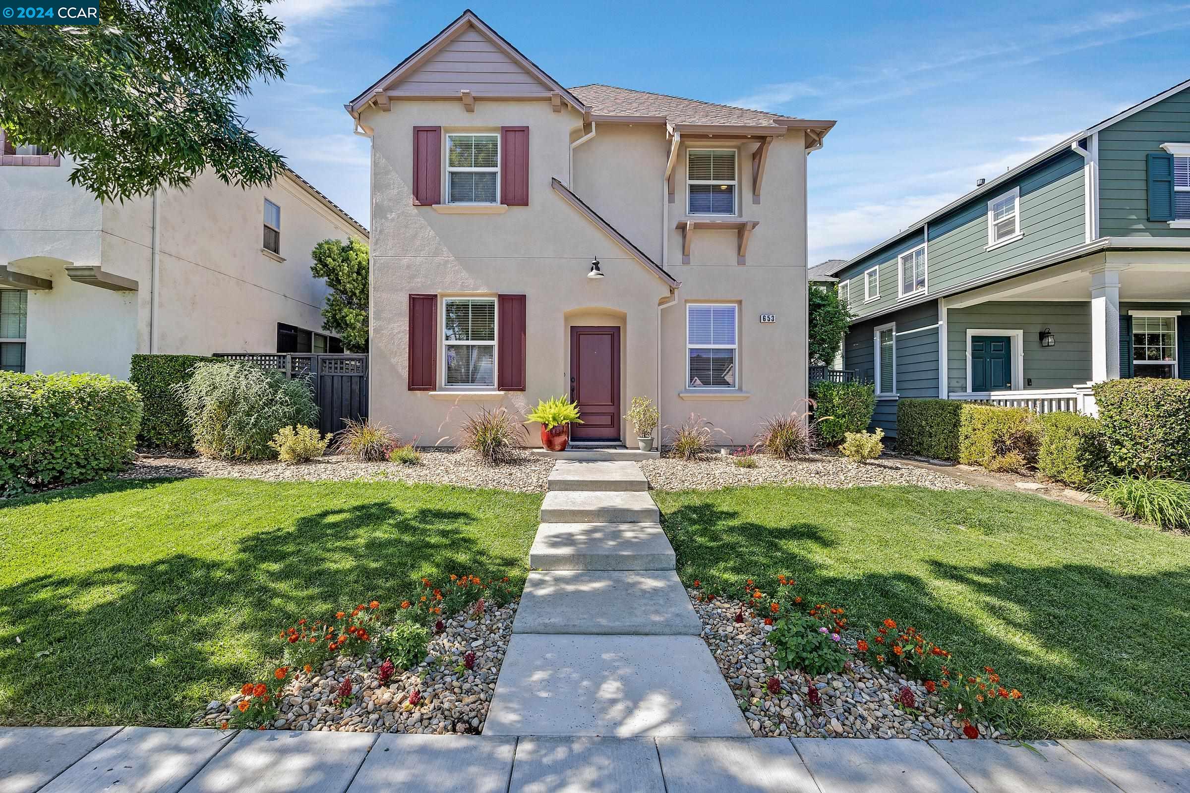 a front view of a house with a yard