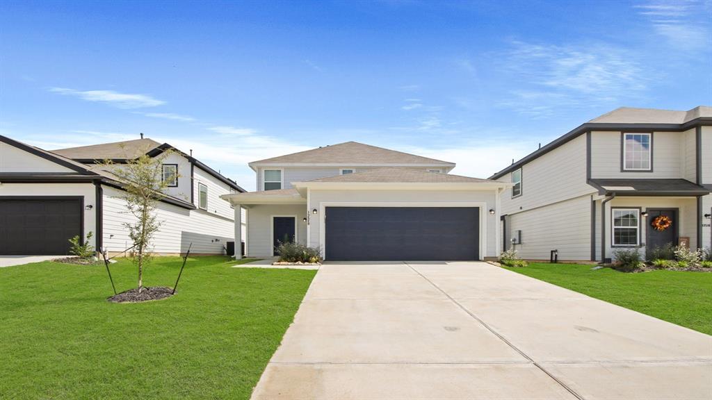 a front view of house with yard and green space