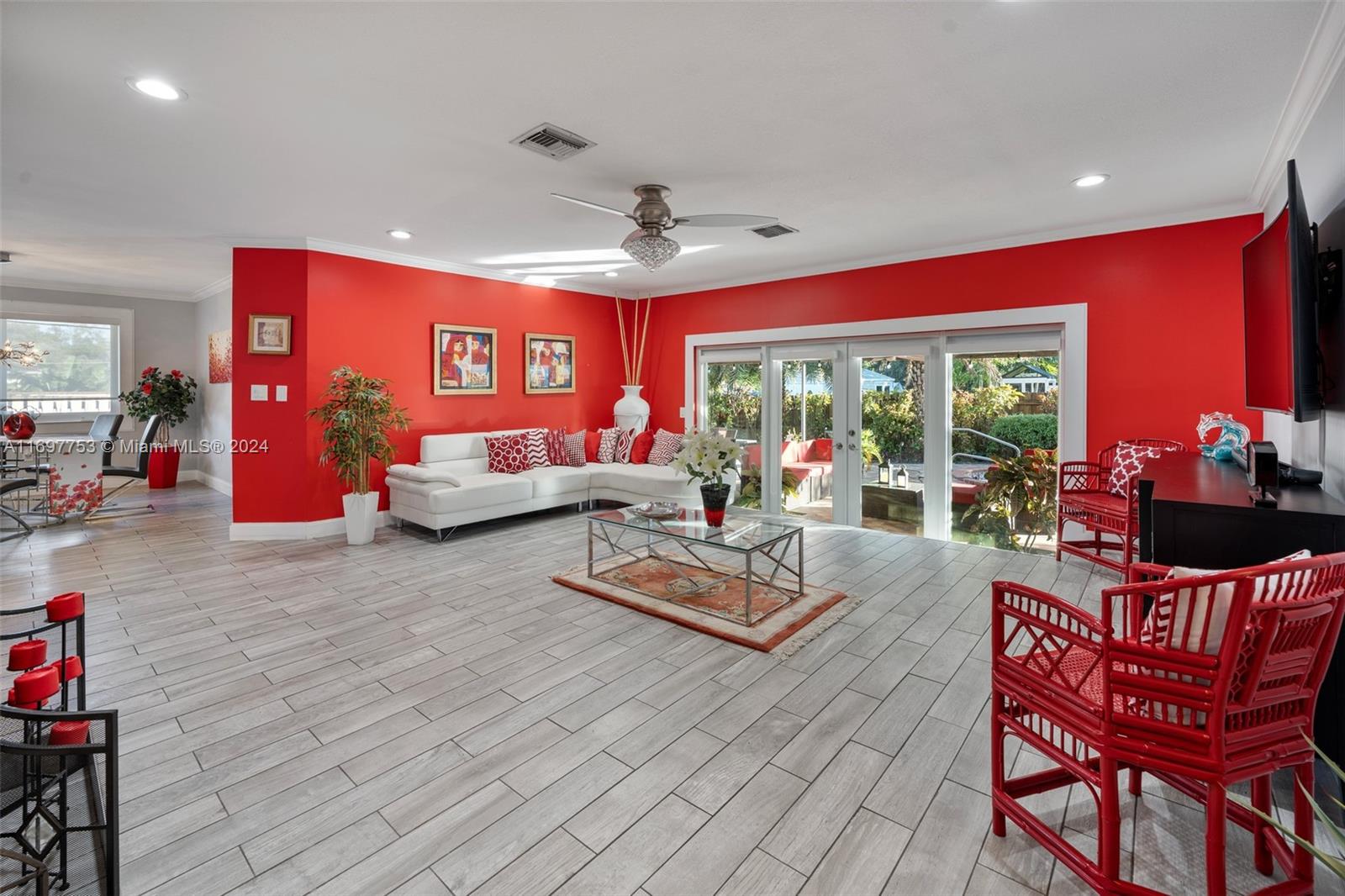 a living room with furniture and a floor to ceiling window