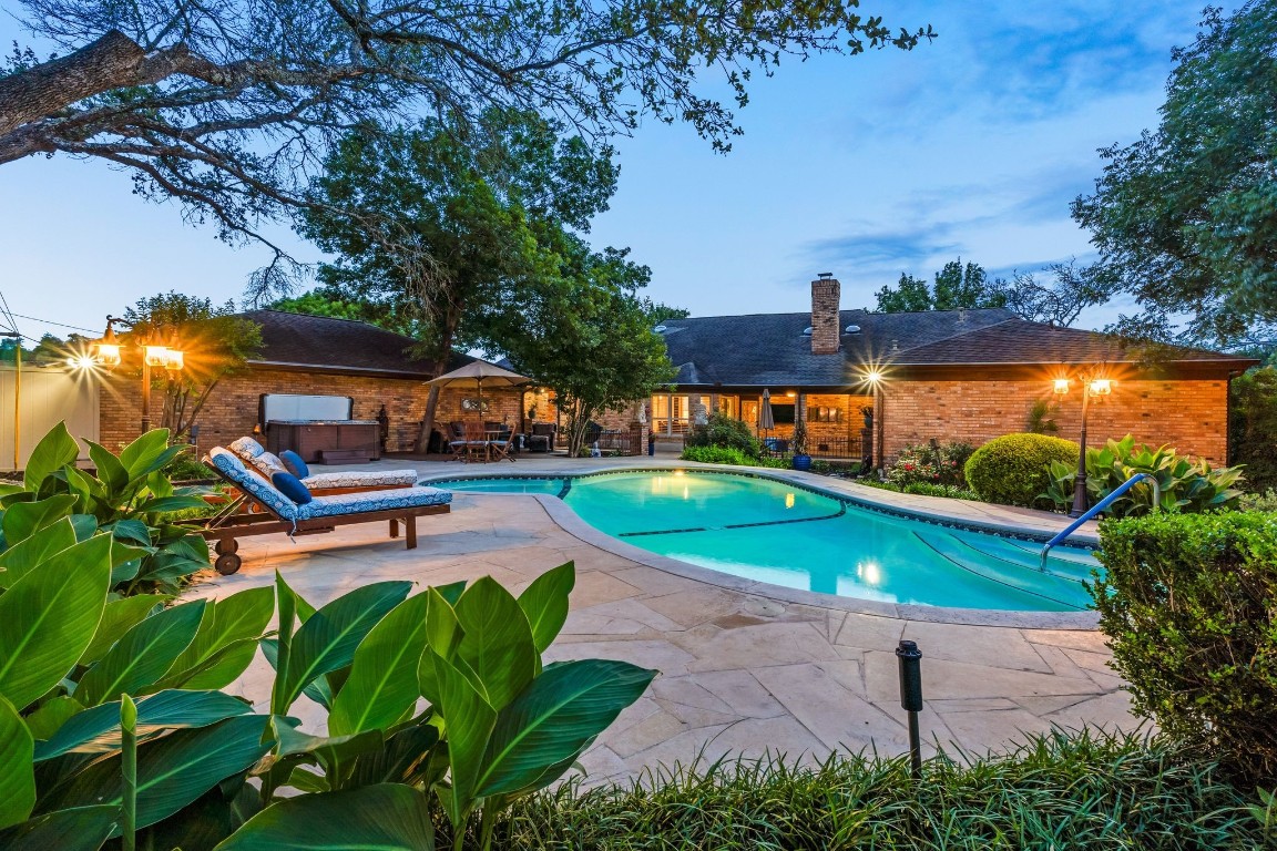 an aerial view of a house with garden space and a patio