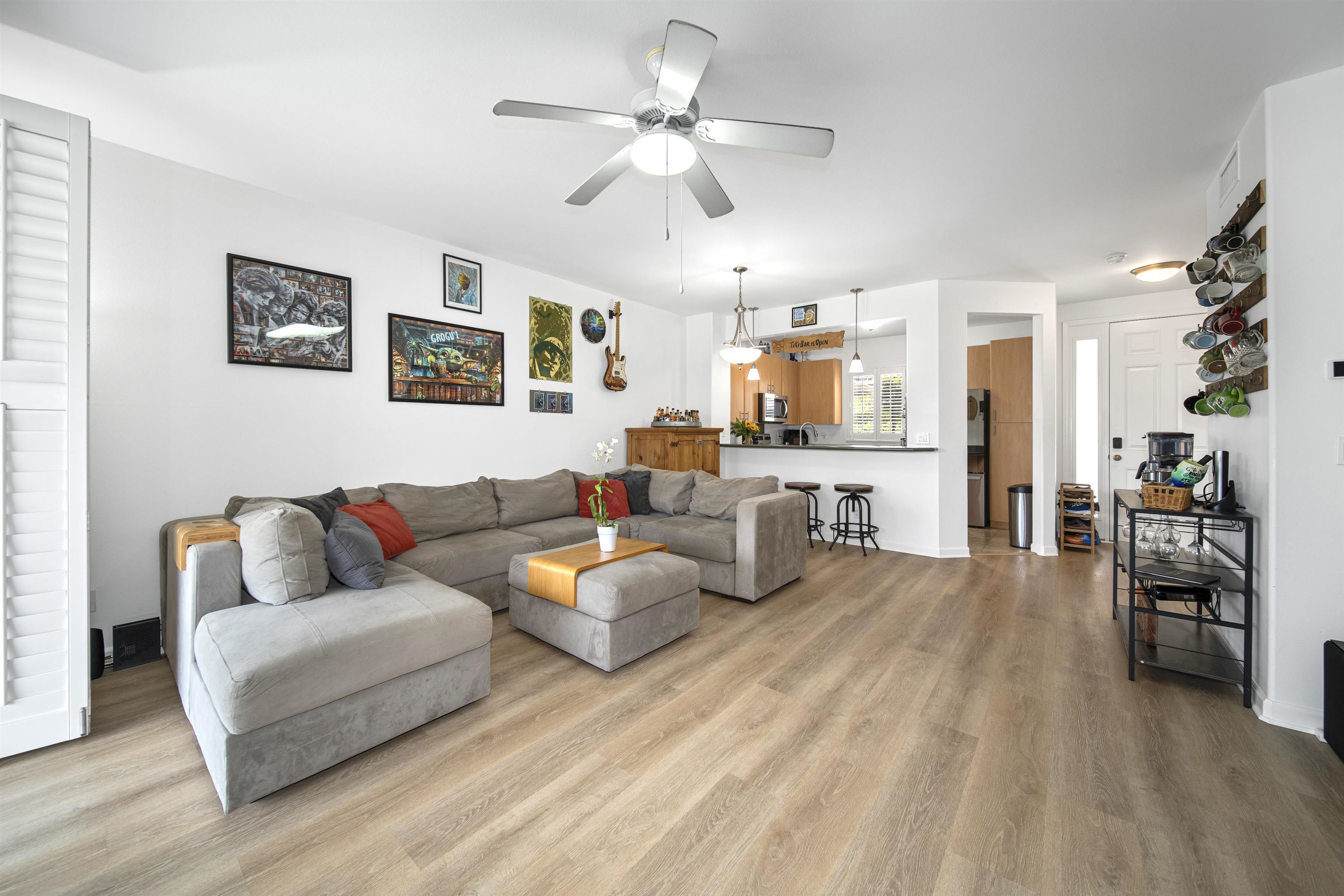 a living room with furniture and kitchen view