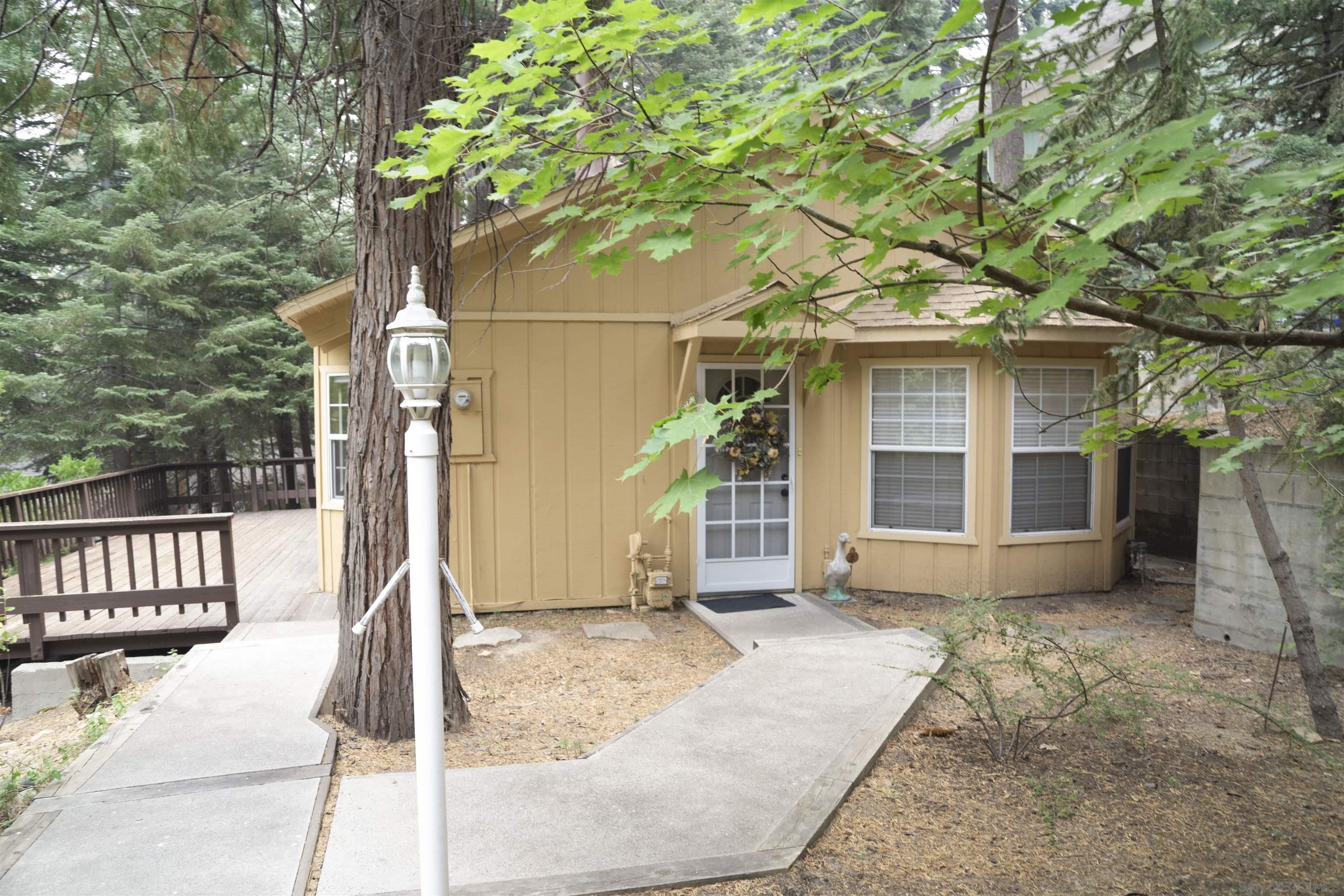 a porch with a tree in front of it