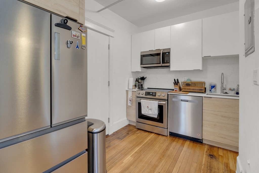 a kitchen with stainless steel appliances a refrigerator sink and microwave