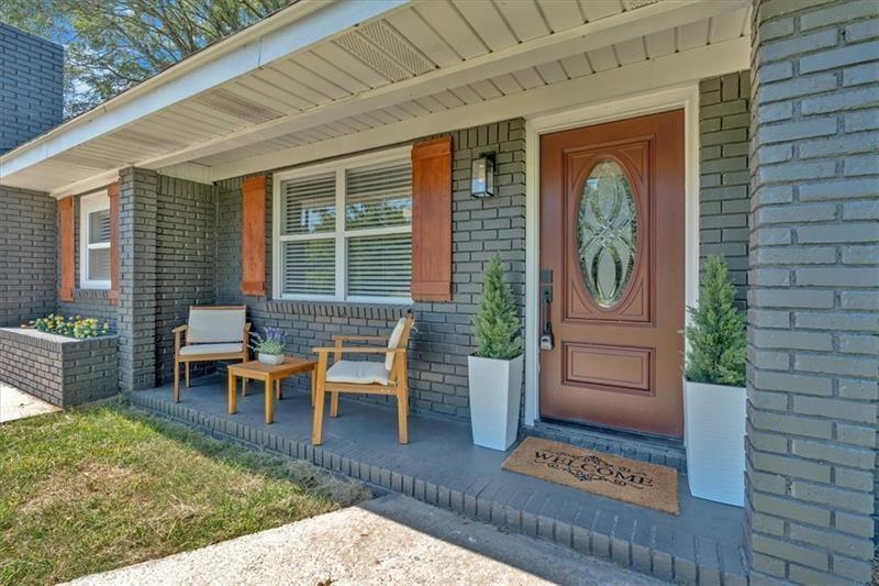 a view of a house with backyard porch and sitting area