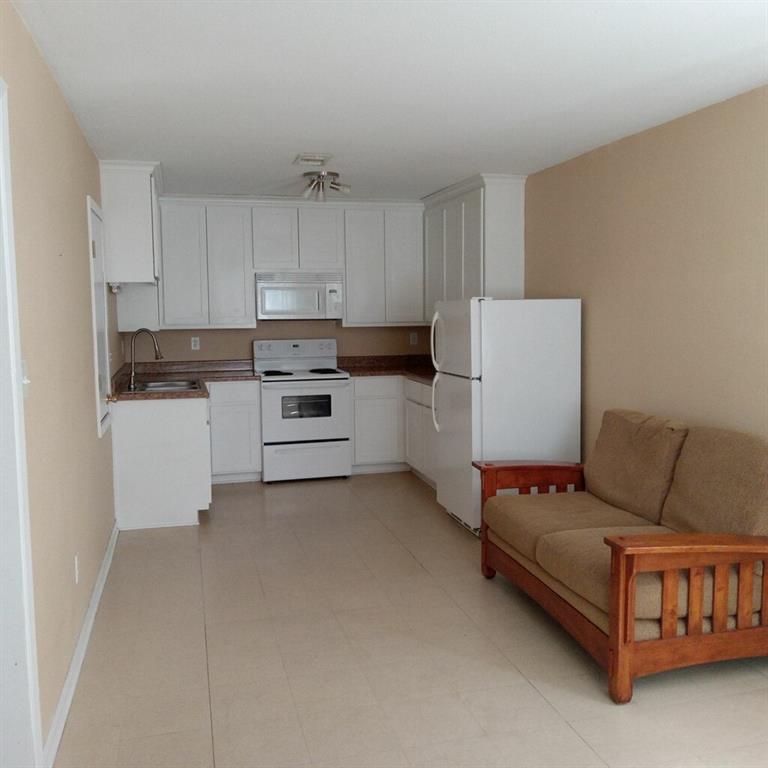 a kitchen with a white cabinets and white appliances