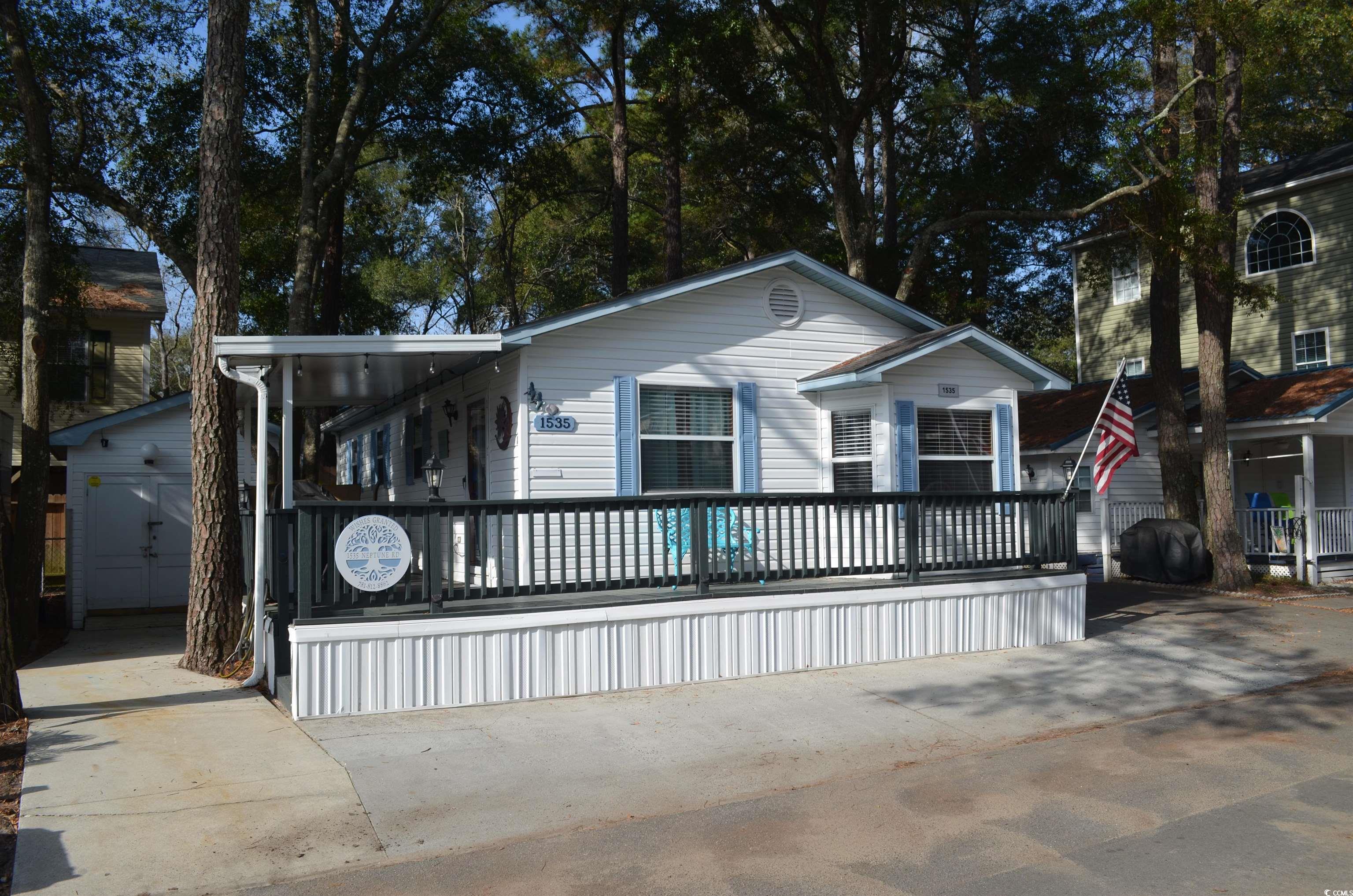 View of front of home featuring a garage and an ou