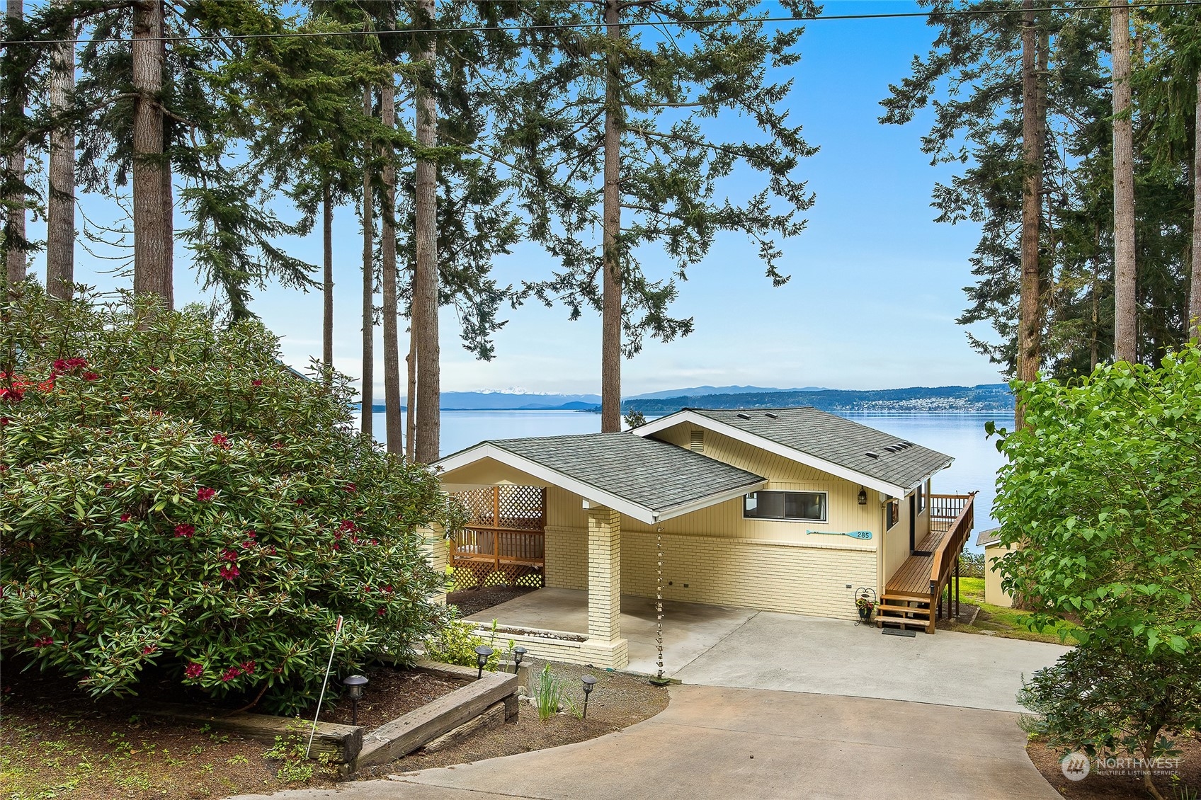 a view of a house with a tree and a yard