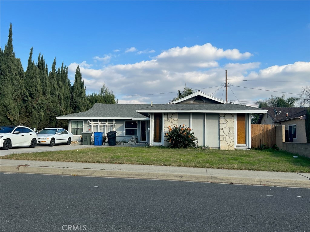 a front view of a house with a garden