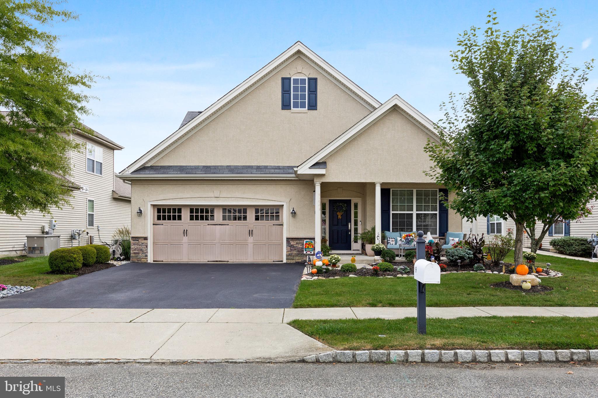 a front view of house with yard and green space