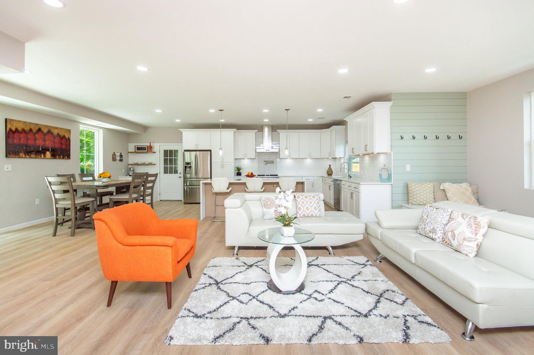 a living room with furniture and kitchen view