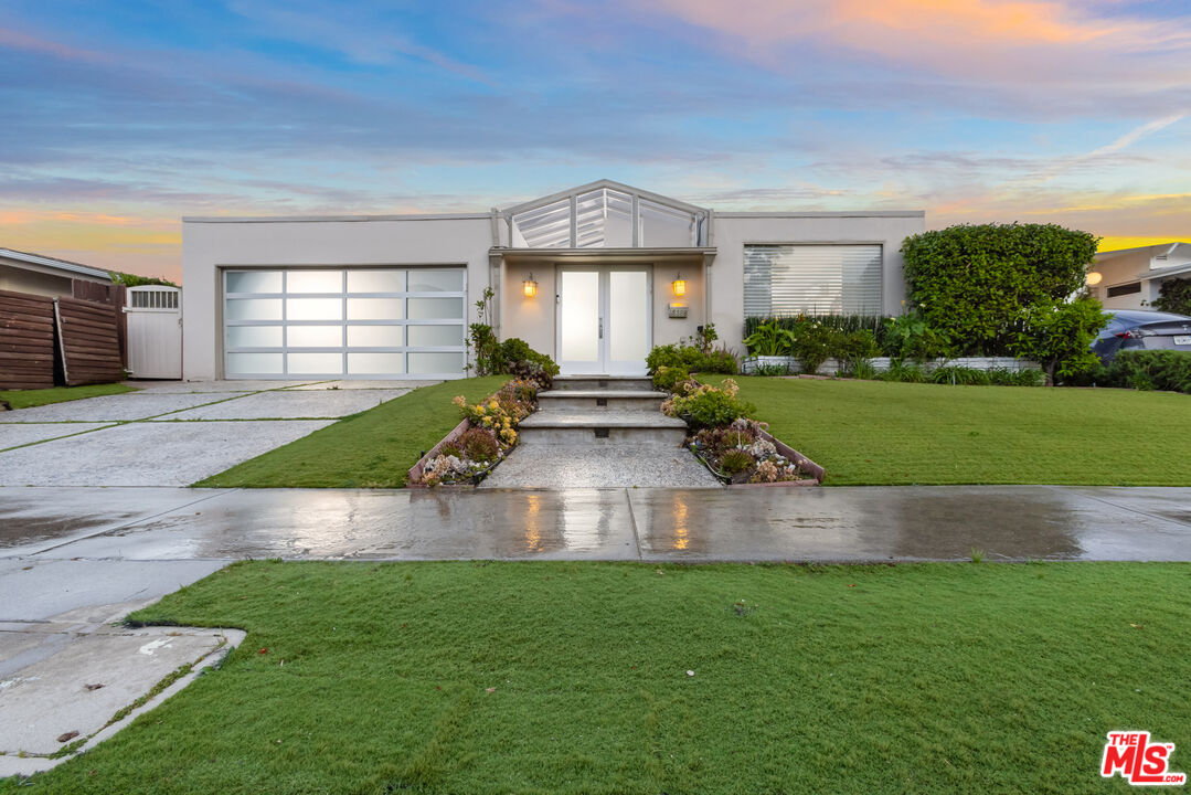 a view of house with backyard and garden