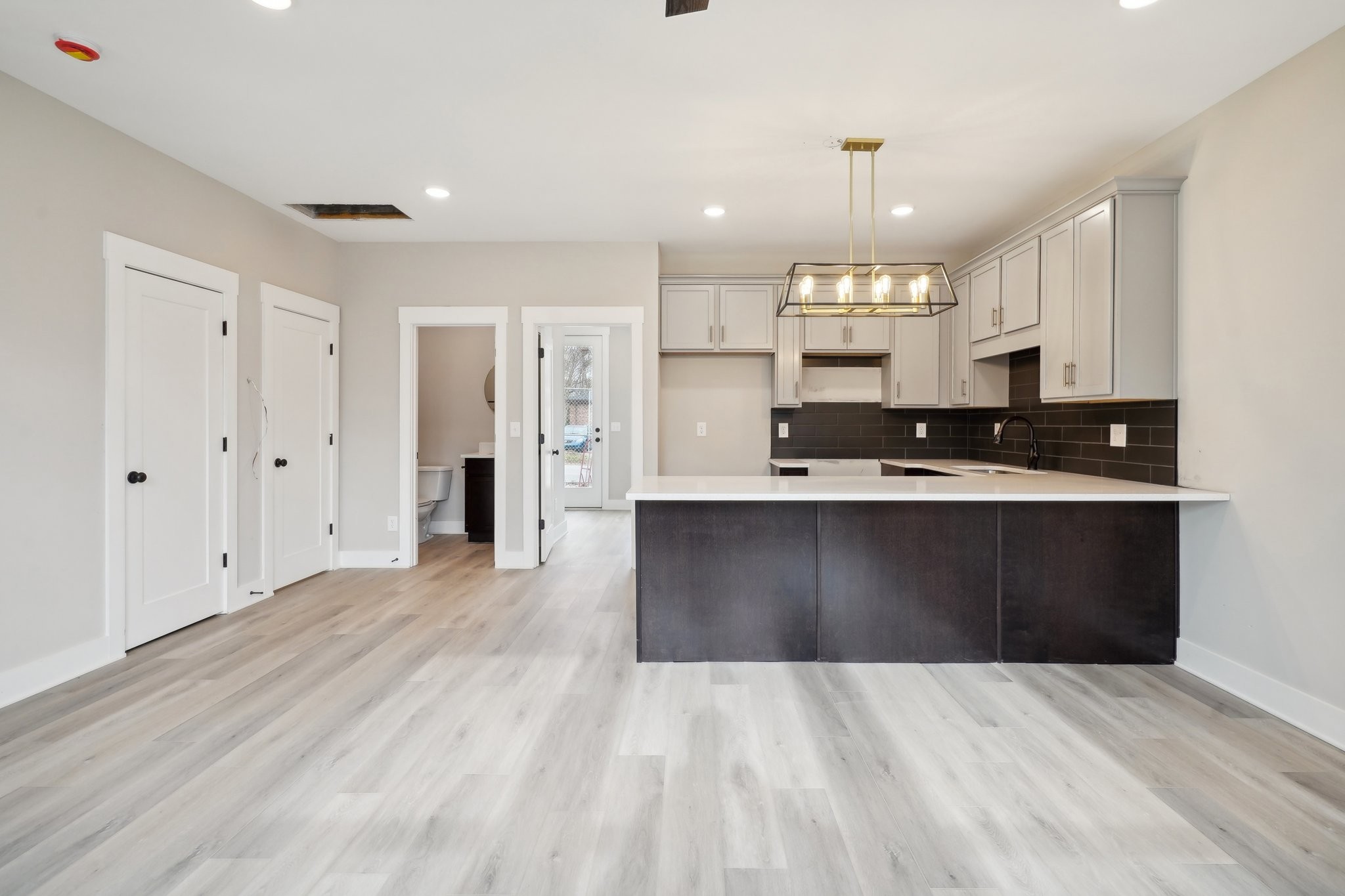 a kitchen with stainless steel appliances a refrigerator sink and cabinets