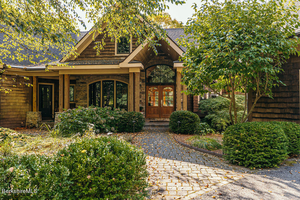 a front view of a house with garden