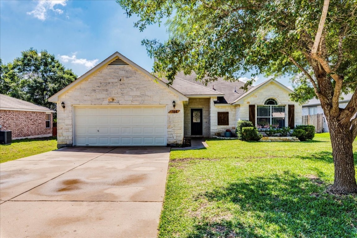 a front view of a house with a yard and garage